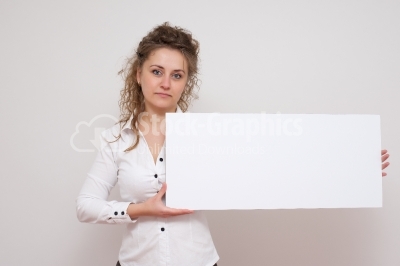 Curly haired woman with white placard and smiling