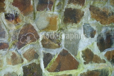Detail of a wall made of colourful natural stone 