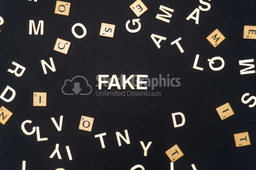 FAKE word written on dark paper background. FAKE text for your concepts