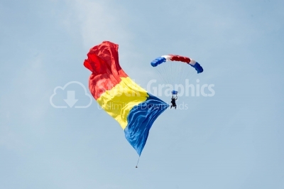 Flying on romanian parachute on the blue sky 