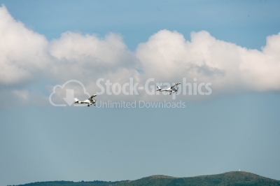 Flying propeller planes over the mountains close-up