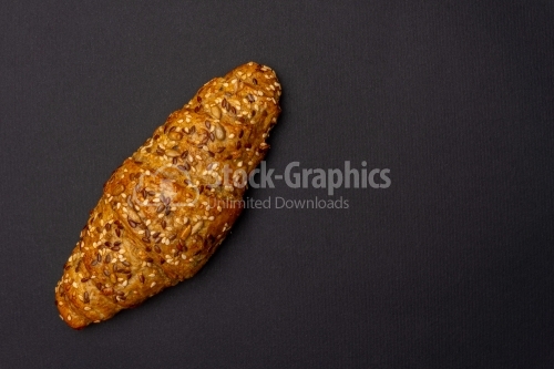 Fresh bread roll with seeds on white background