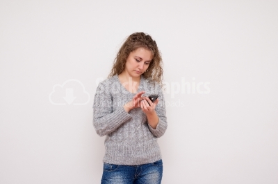 Girl sending a text message on her smartphone isolated 