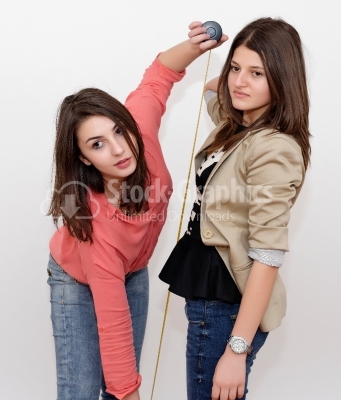 Girls with measuring tape isolated in white