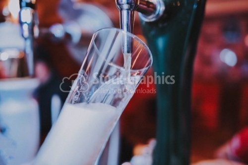 Glass of beer at the dispenser