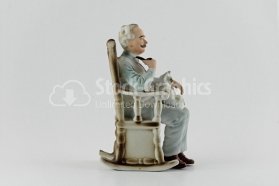 Grandfather sitting on chair porcelain statuette