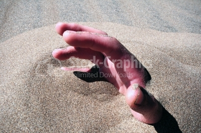 Hand of a man in the sand