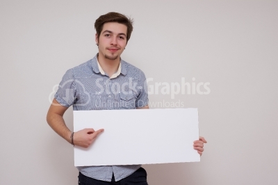 Happy smiling young business man showing blank signboard, isolat
