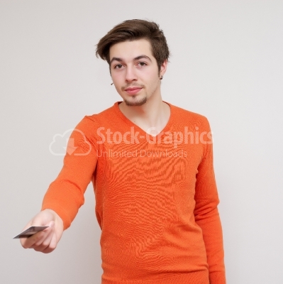 Happy smiling young man holding a credit card isolated on white 