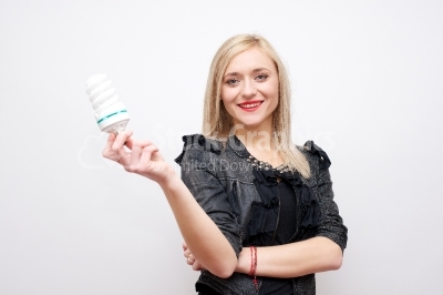 Isolated businesswoman holding light bulb bright idea
