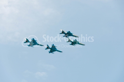 Jet stunts on blue sky