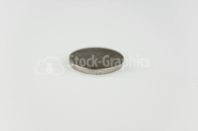 Lithium button cell on white- Stock Image