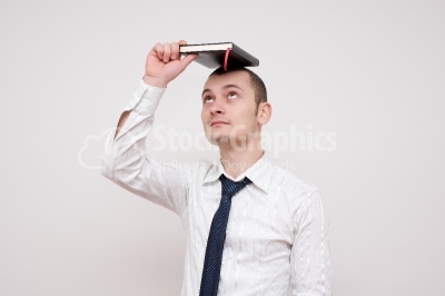Male with notebook on his head