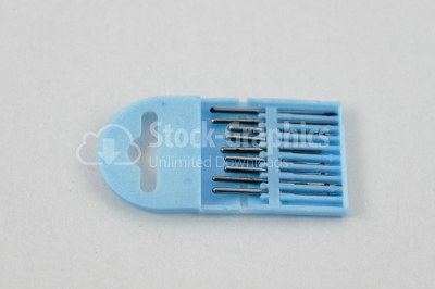 Needles in blue support on white background