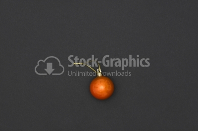 Orange Christmas Bauble Tied Over Black Background