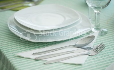 Plates and cutlery on wooden table
