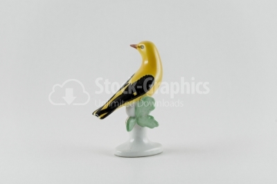 Porcelain yellow bird statue on white