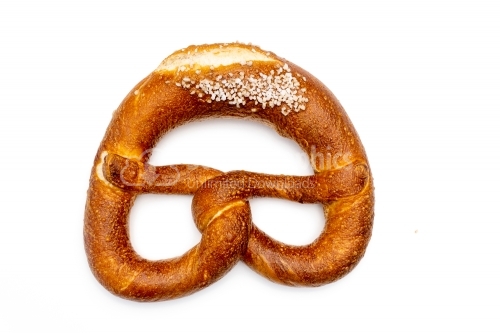 Pretzel with large salt crystals isolated on white background.