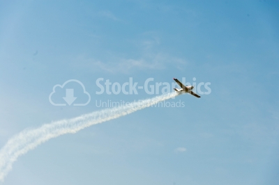 Propeller plane with vapor trail behind