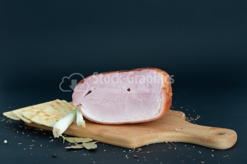 "Prague" baked ham isolated on cutting board