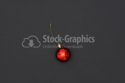 Red Christmas Bauble Tied Over Black Background
