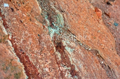 Red rough stone texture closeup horizontal background