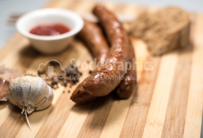 Sausage roasted on the grill with garlic