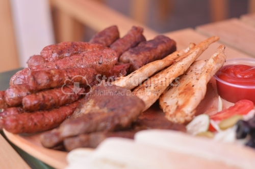 Sausages, chicken breast, pork and "Mici", all grilled.