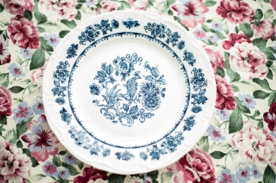 Simple vintage dinner plate over a floral background
