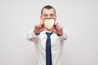 Smiling Doctor holding in his hands  metalic red heart