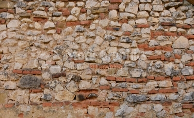 Stone wall built with many bricks in it