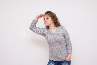 Surprised young woman looking into distance
