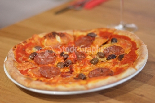 Tasty pizza with salami, cheese and olives