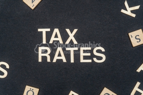 TAX RATES word written on dark paper background. TAX RATES text for your concepts