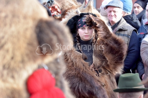 The young girl play the bear. New Year's popular dance.