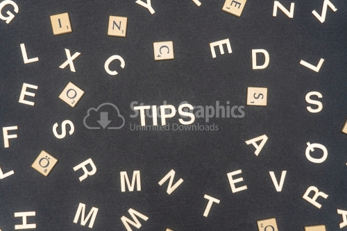 TIPS word written on dark paper background. TIPS text for your concepts