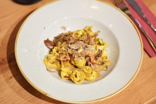Tortellini pasta with pork and vegetables.