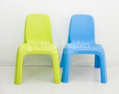 Two chairs standing near wall