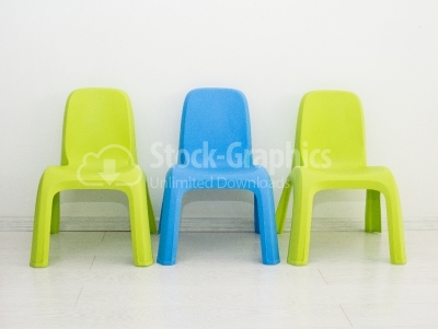 Two chairs standing near wall