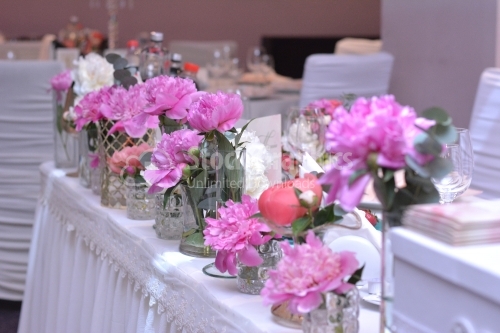 Wedding reception table full of flowers