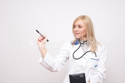 Woman doctor writing something on screen or transparent glass