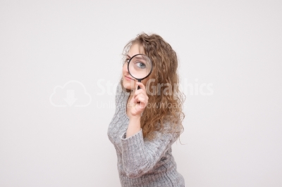 Woman look through magnifying glass and smile 
