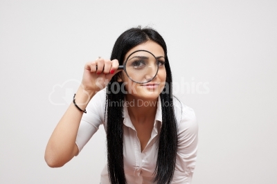 Woman look through magnifying glass and smile