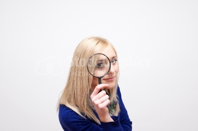 woman looking through a magnifying glass