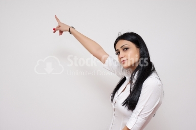 Woman pointing her finger towards blank space