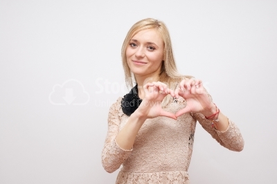 Woman showing hands heart on a white background