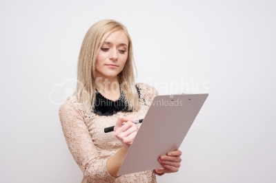 Woman using a clipboard - Stock Image