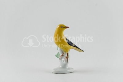 Yellow bird porcelain statue on white