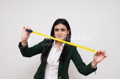 Young and beautiful girl with the measuring tape isolated on whi