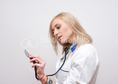 Young beautiful successful female doctor with stethoscope 